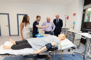 Dr Michael Dover, Emergency Medicine trainee, demonstrating some of the airway features of the new SimMan Essential to members of the McDermott family with Dr John Cronin, Clinical Lead for EMSEC