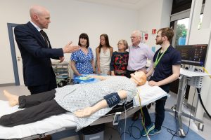 Pic ending 297 - Dr John Cronin, Clinical Lead for EMSEC, demonstrating some of the features of the new SimMan Essential to members of the McDermott family